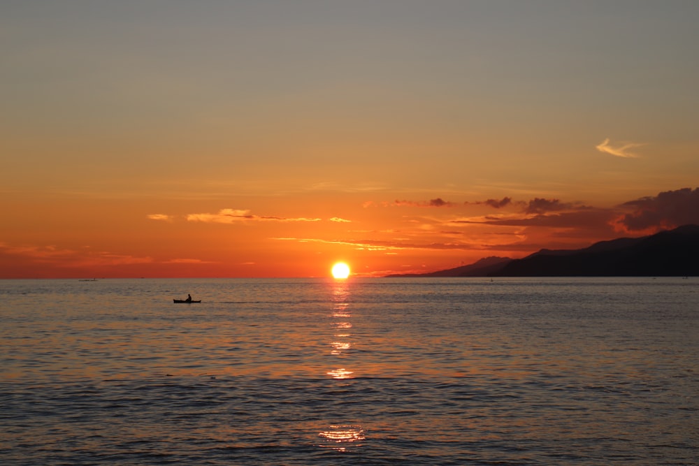 silhouette of people on beach during sunset