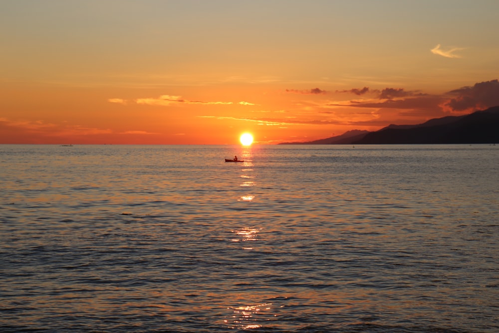 body of water during sunset