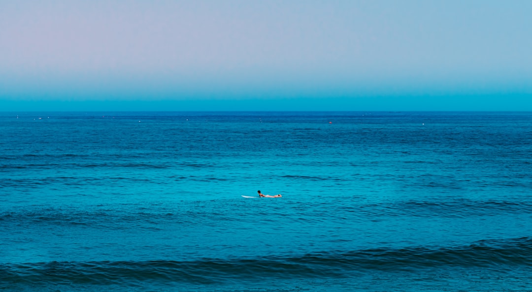 person surfing on blue sea during daytime