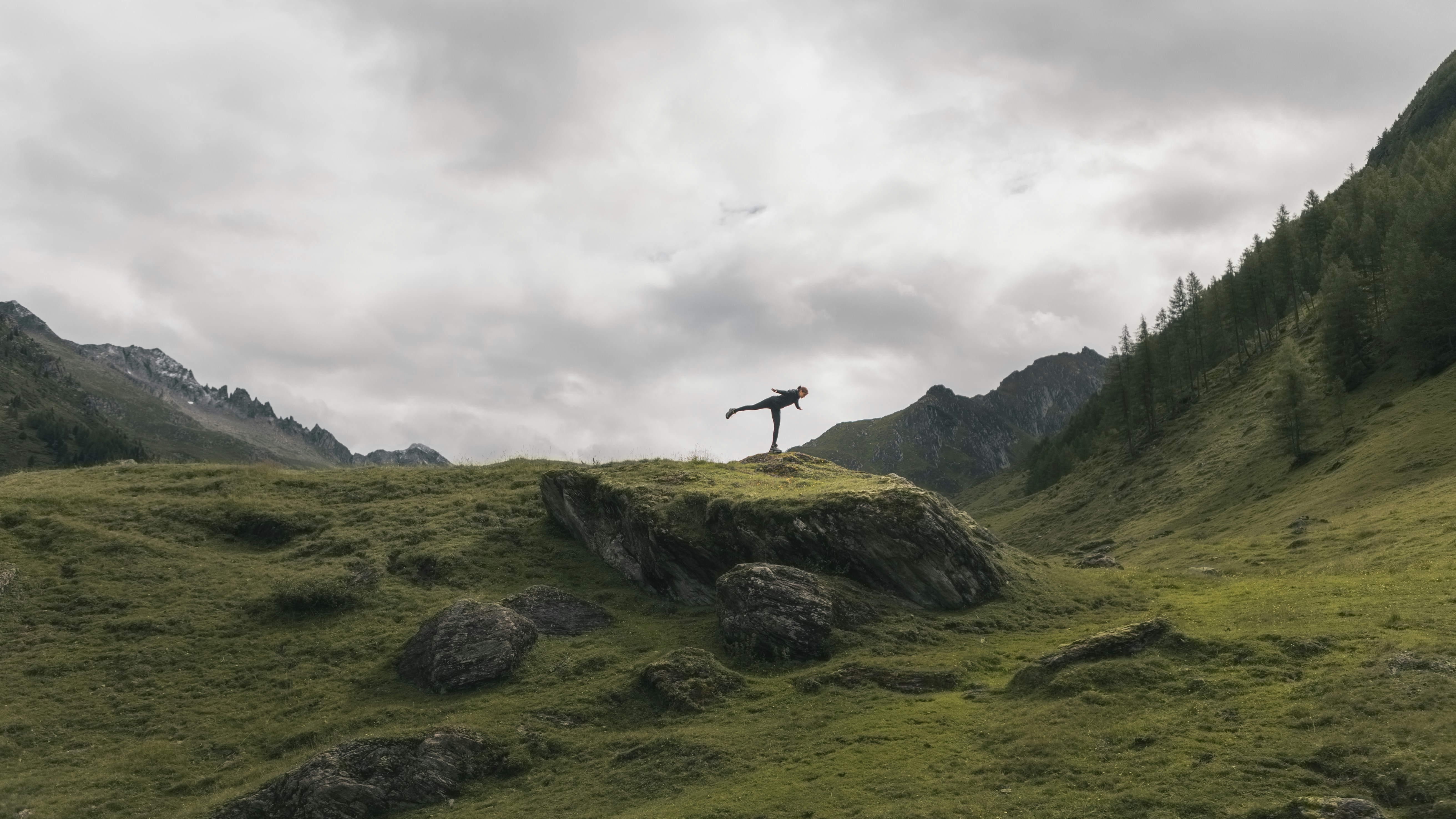 person standing on rock formation during daytime