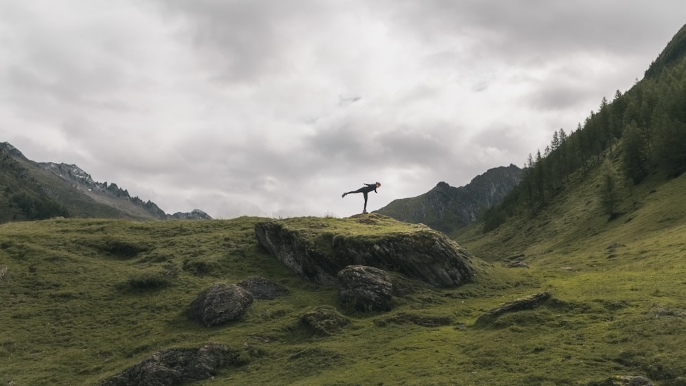 person standing on rock formation during daytime