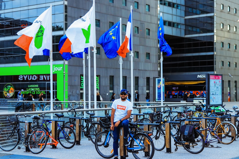 man in white t-shirt riding bicycle during daytime