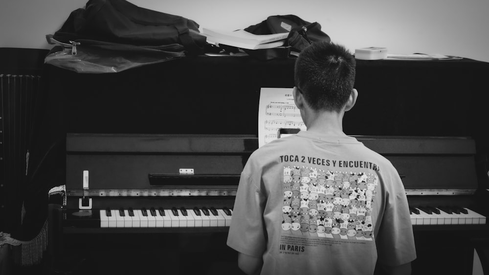 woman in white long sleeve shirt playing piano