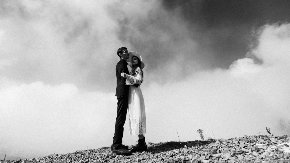 grayscale photo of man and woman kissing