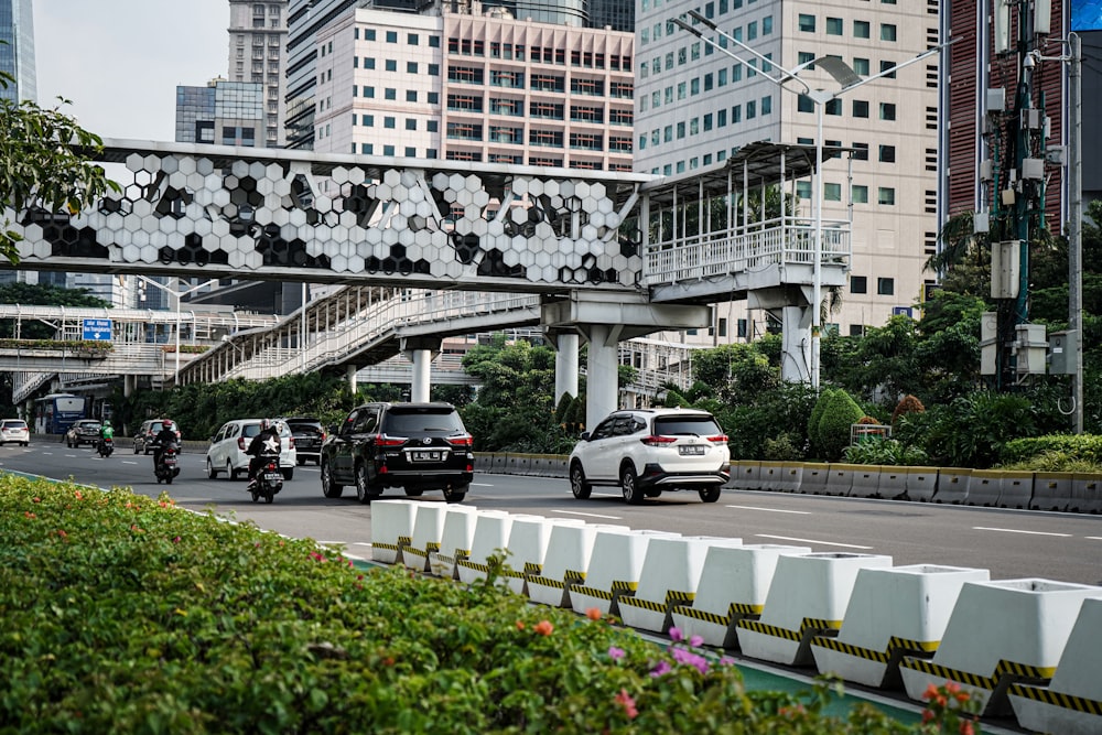 cars parked on parking lot near high rise buildings during daytime