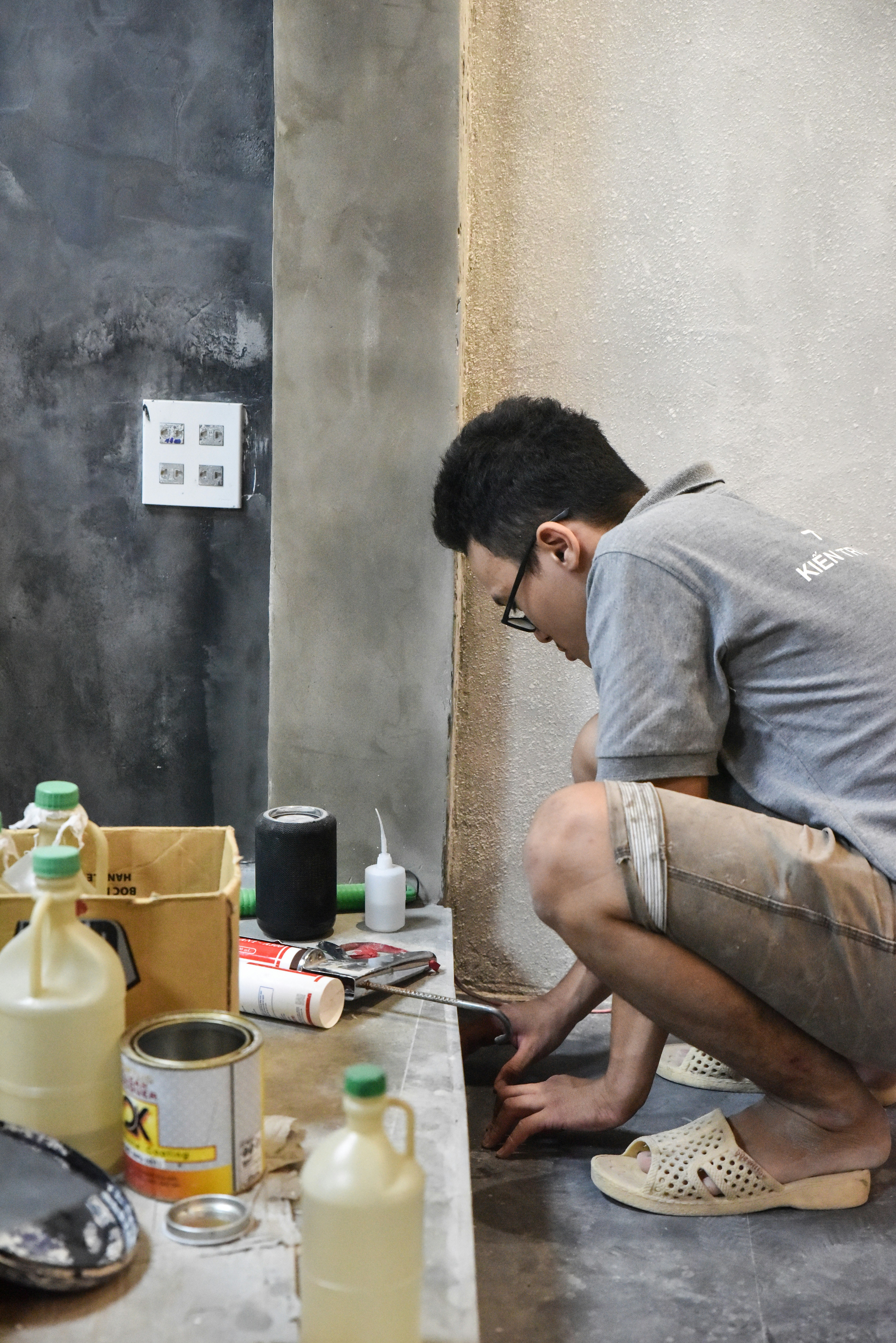 Worker laying tiles during a bathroom renovation