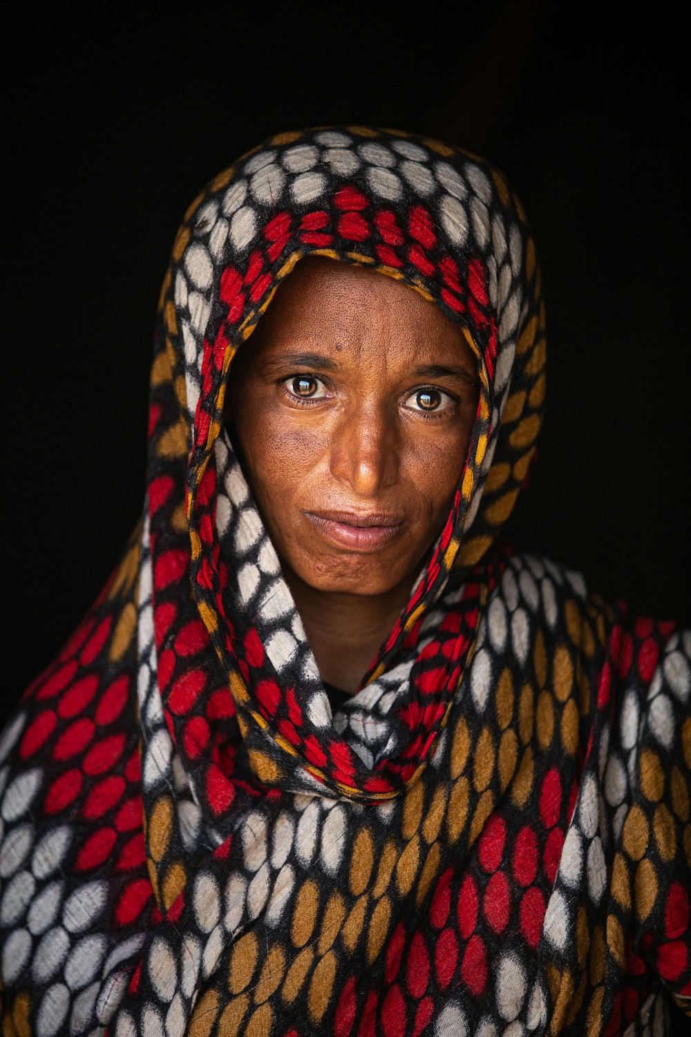 woman in blue white and red scarf