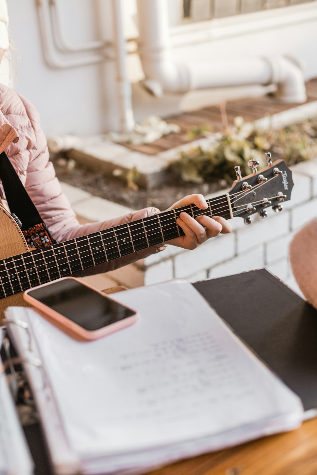 person playing brown acoustic guitar