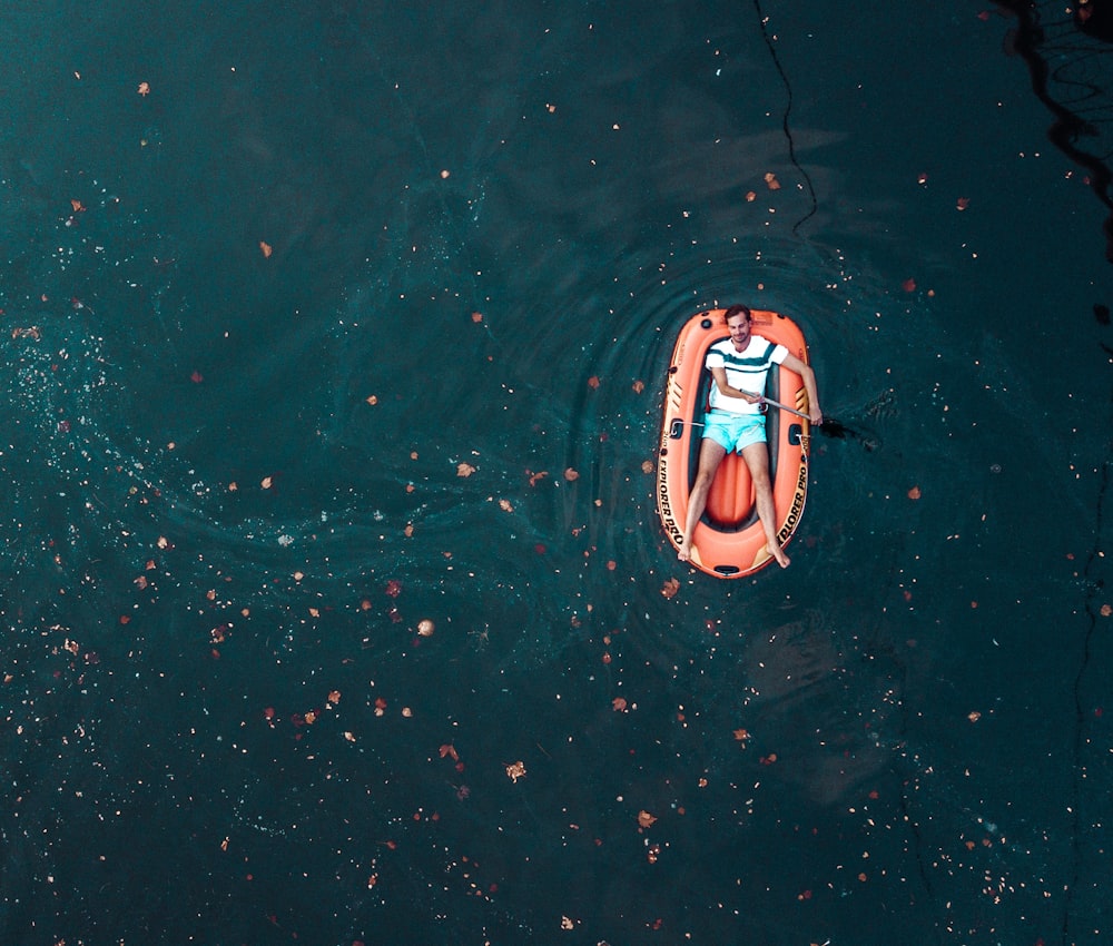 orange and white kayak on water