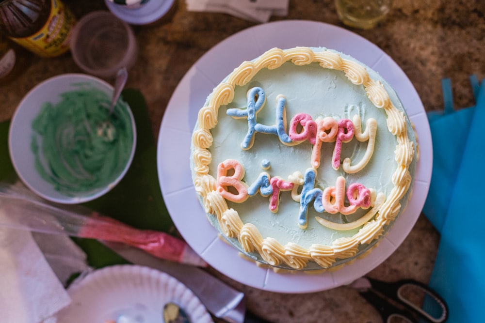 white and gold round cake with candles on top