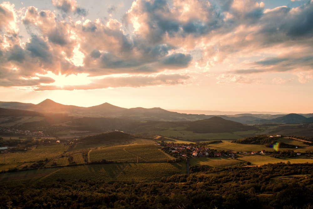 brown mountains under white clouds during daytime