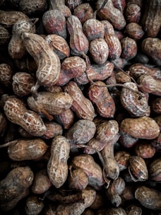 Close-up of fresh, shelled groundnuts arranged in a rustic basket.