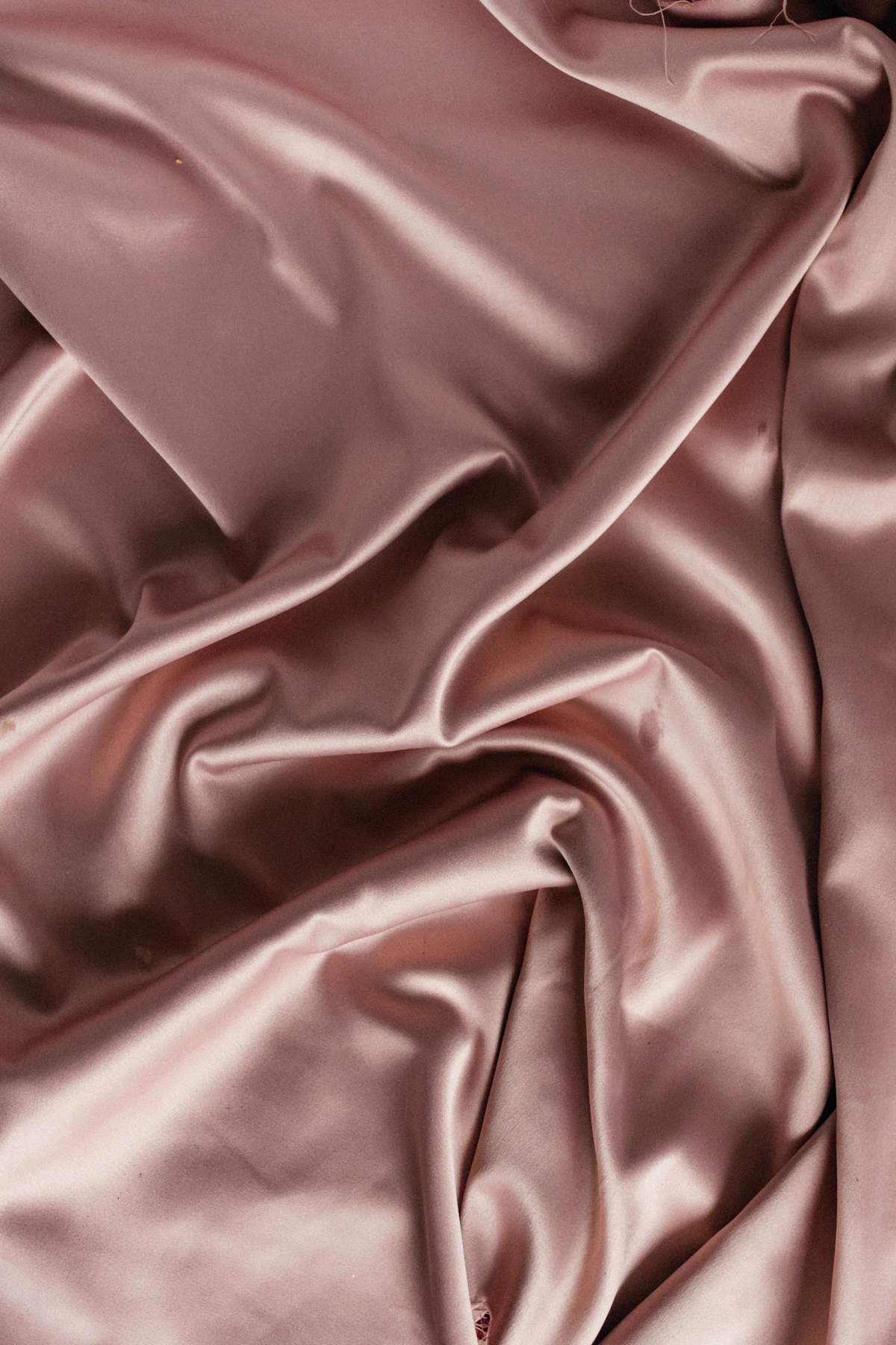 Soft folds of rose-colored satin