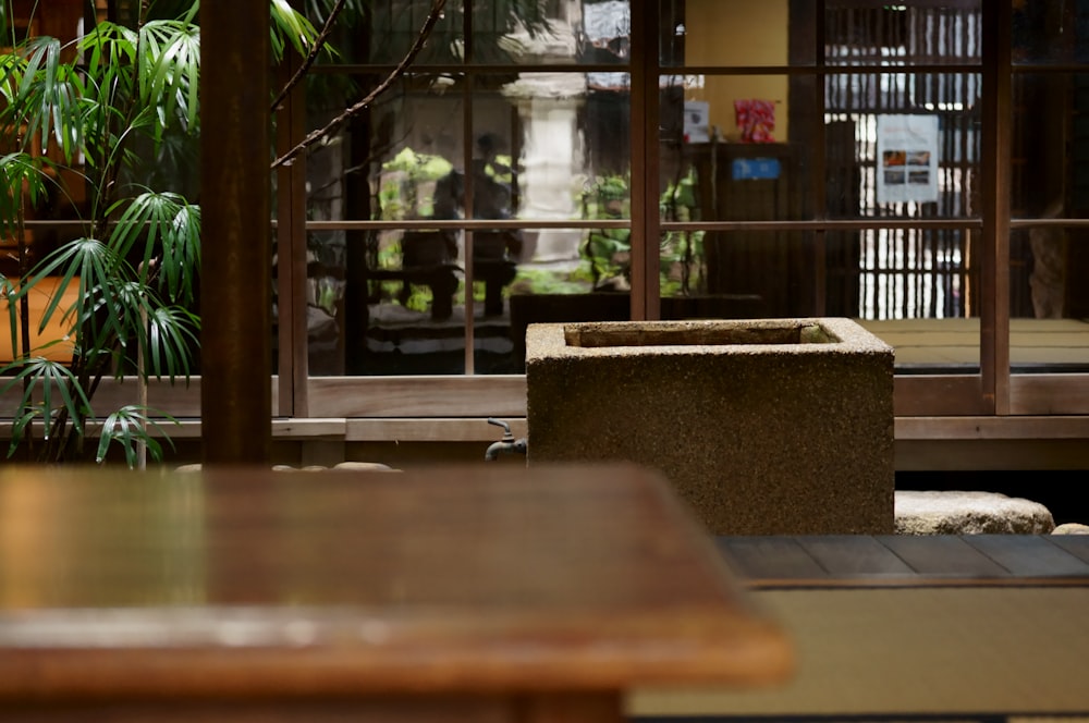 brown wooden table near green plants