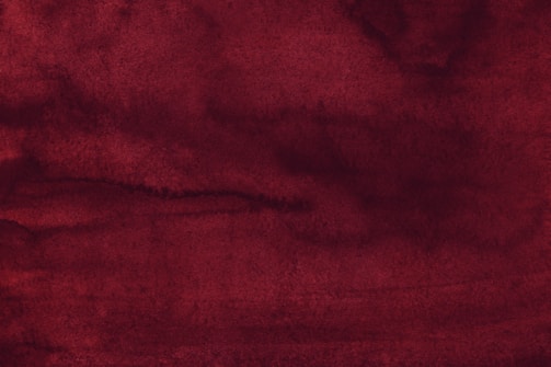 A deep red background with light beige contact icons.