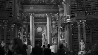 grayscale photo of people in a building