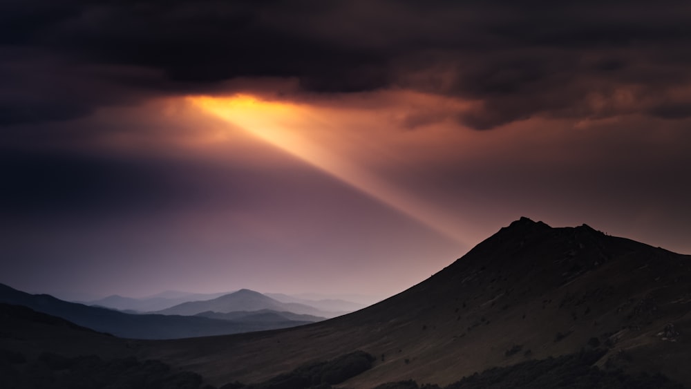 gray mountains under white clouds during daytime