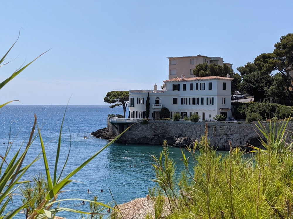 white and brown concrete building beside sea during daytime