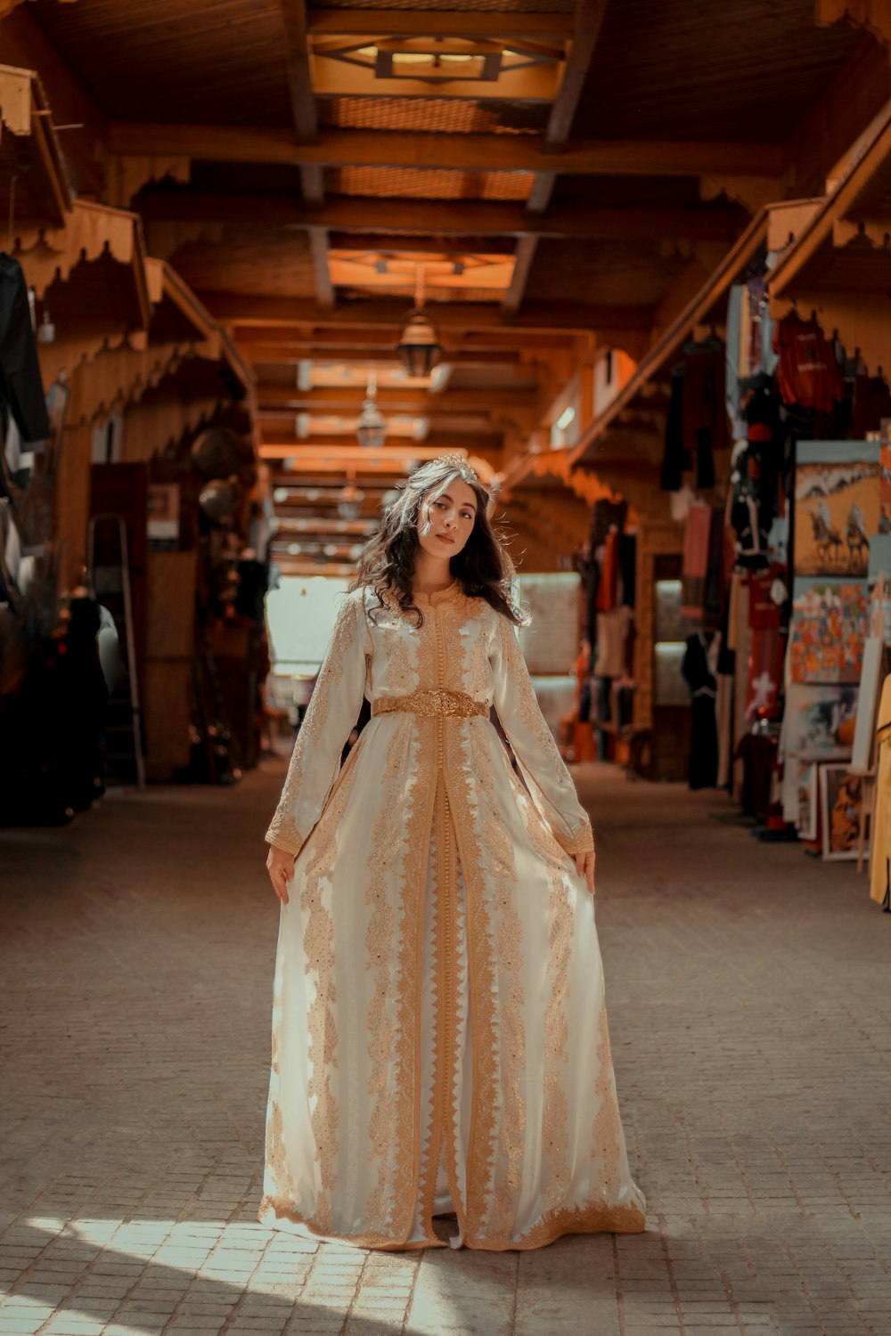 woman in white floral dress standing on street during daytime