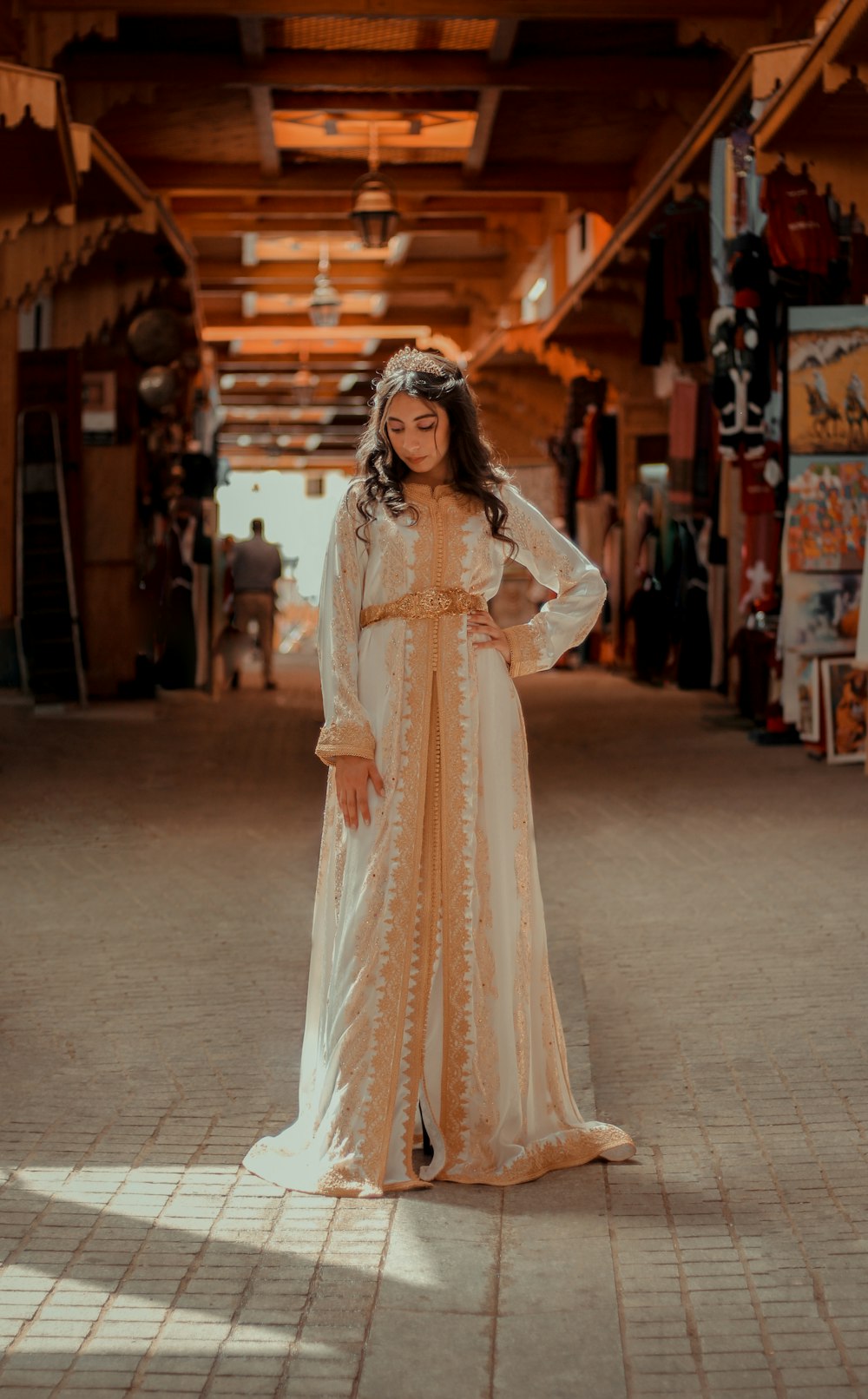 woman in white long sleeve dress standing on gray concrete floor during daytime