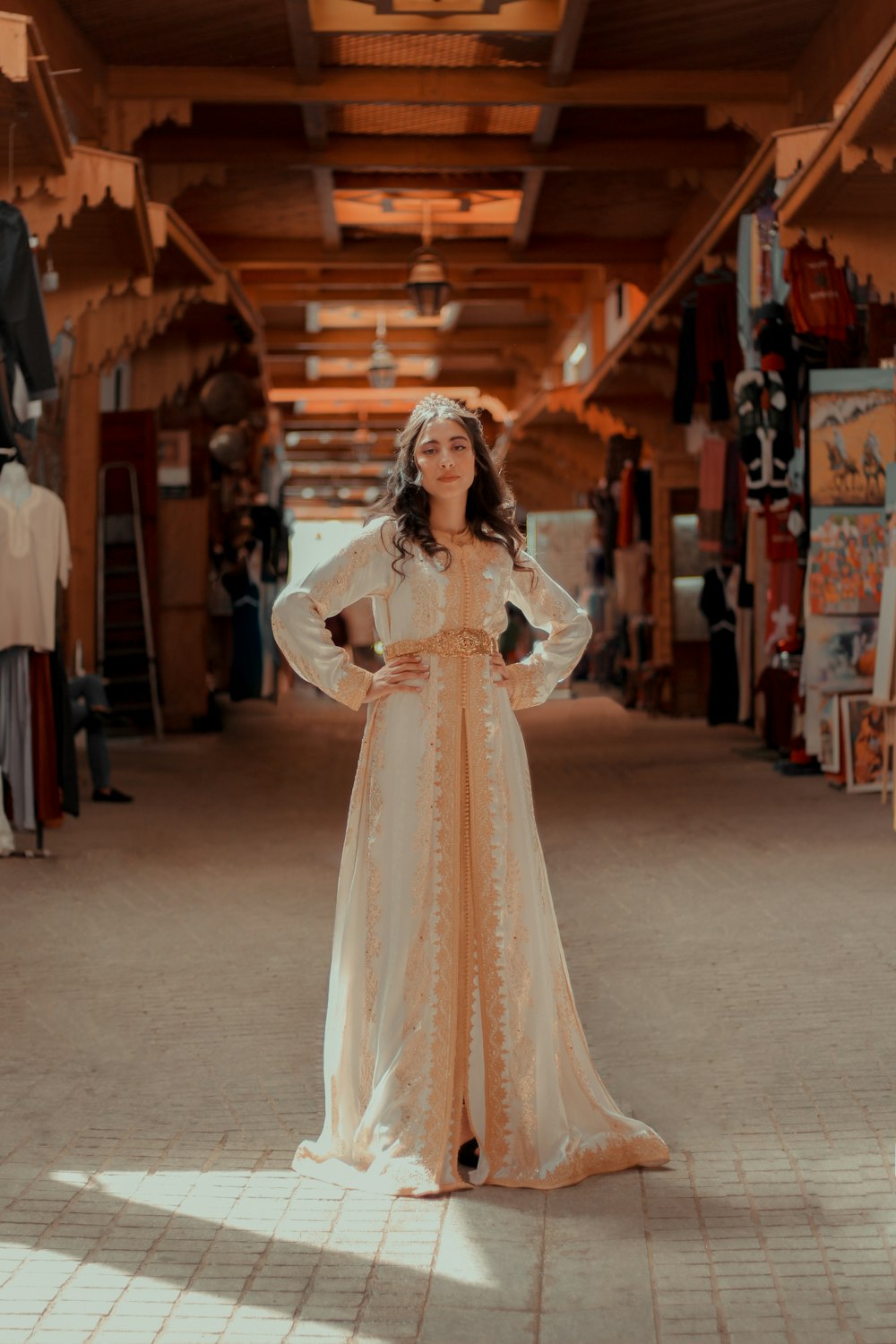 woman in white floral lace long sleeve dress standing on white floor