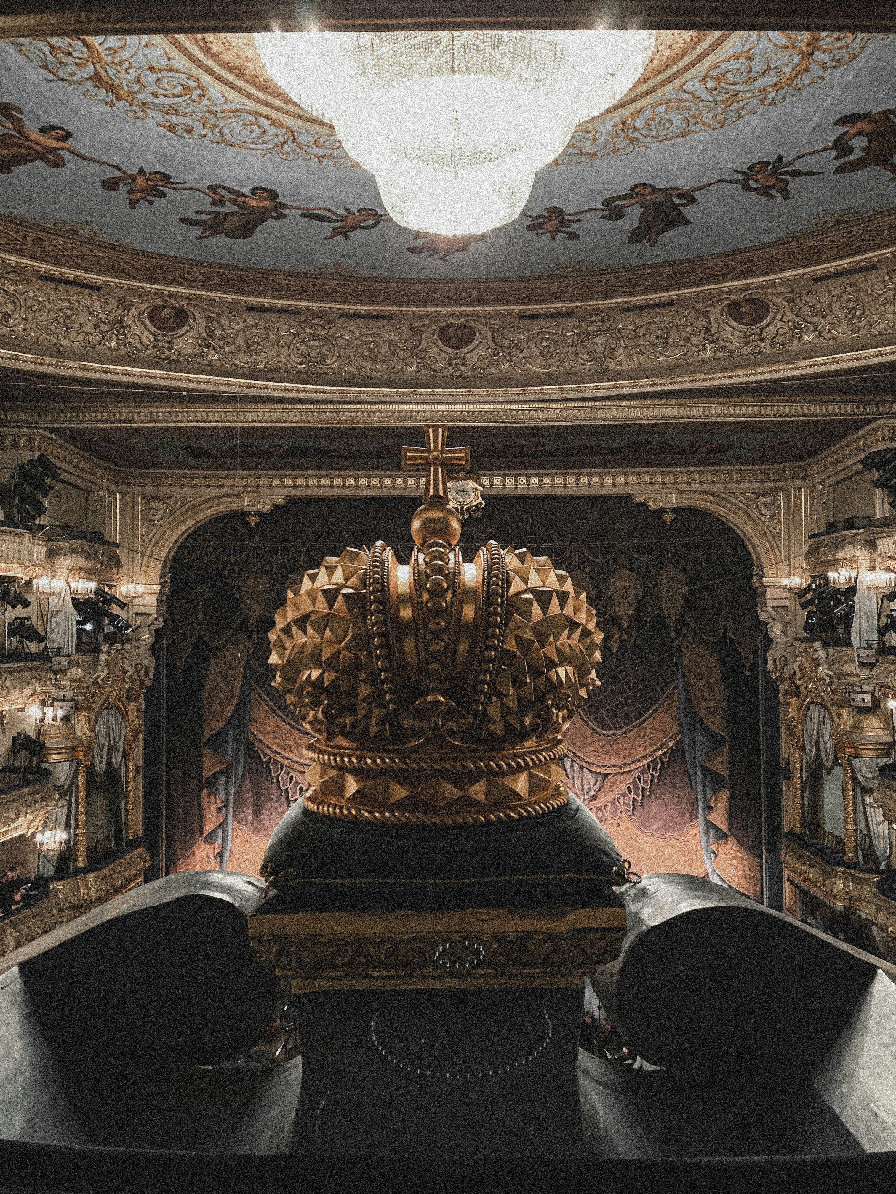 Ornate golden crown resting on a throne in a dimly lit castle chamber