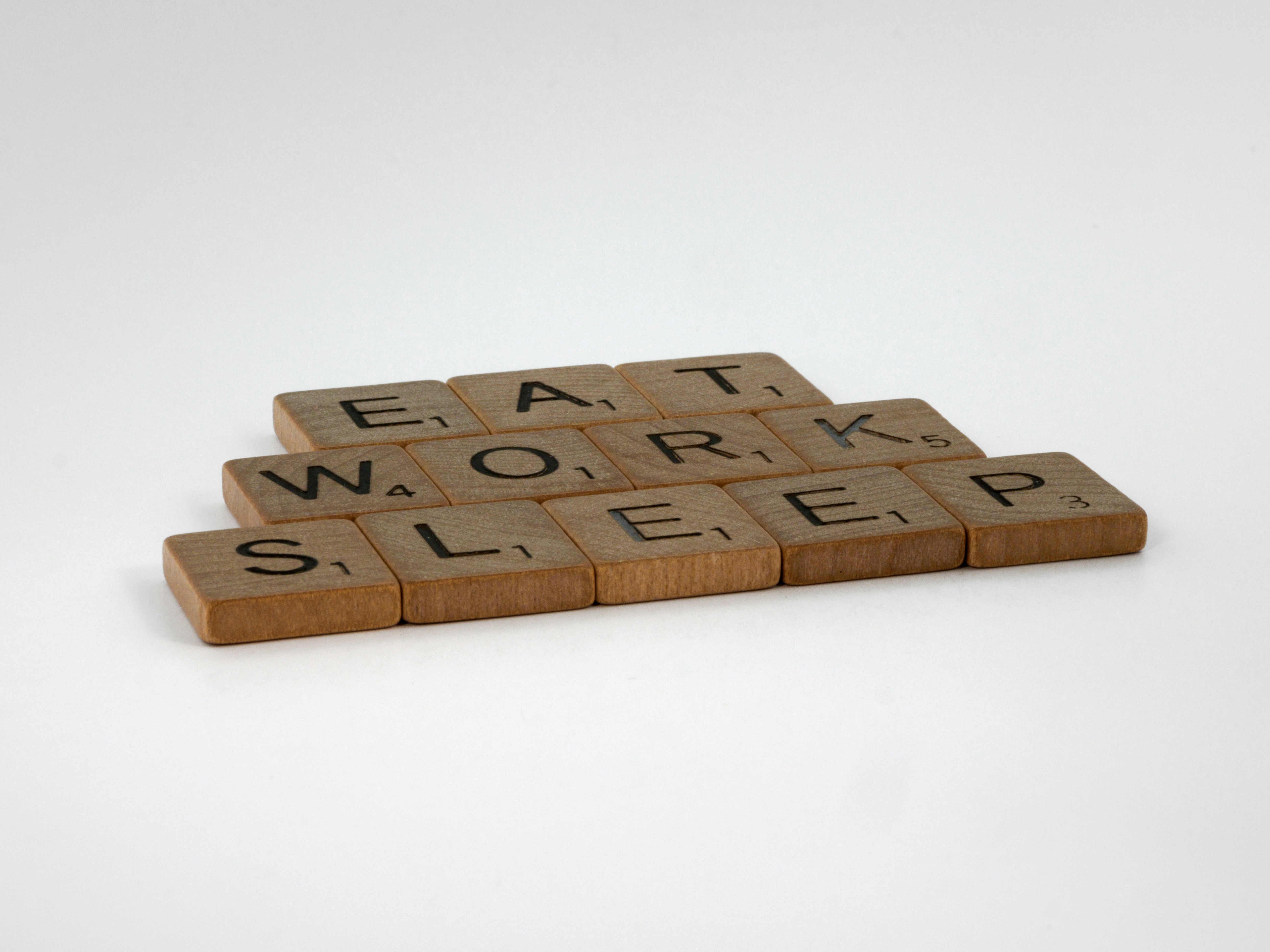 scrabble, scrabble pieces, lettering, letters, wood, scrabble tiles, white background, words, quote, letters, type, typography, design, layout, focus, bokeh, blur, photography, images, image, eat, work, sleep, work life balance, eat work sleep, life, working week, the grind, working for the man, 9-5, nine to five,