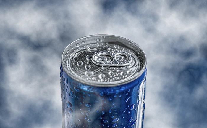 Close-up of a chilled Brissa can with condensation on a sunny summer table.