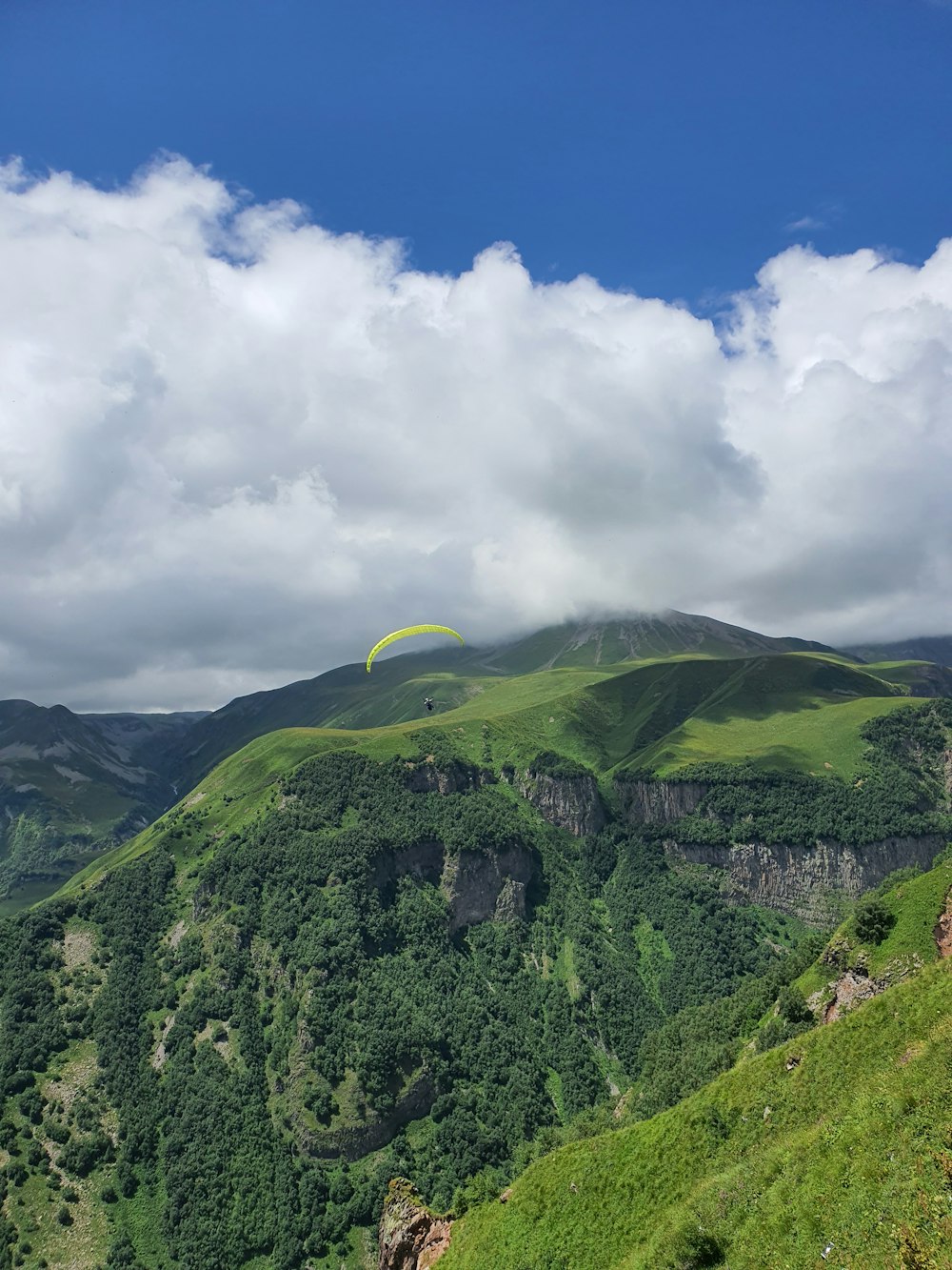 green mountain under white clouds during daytime