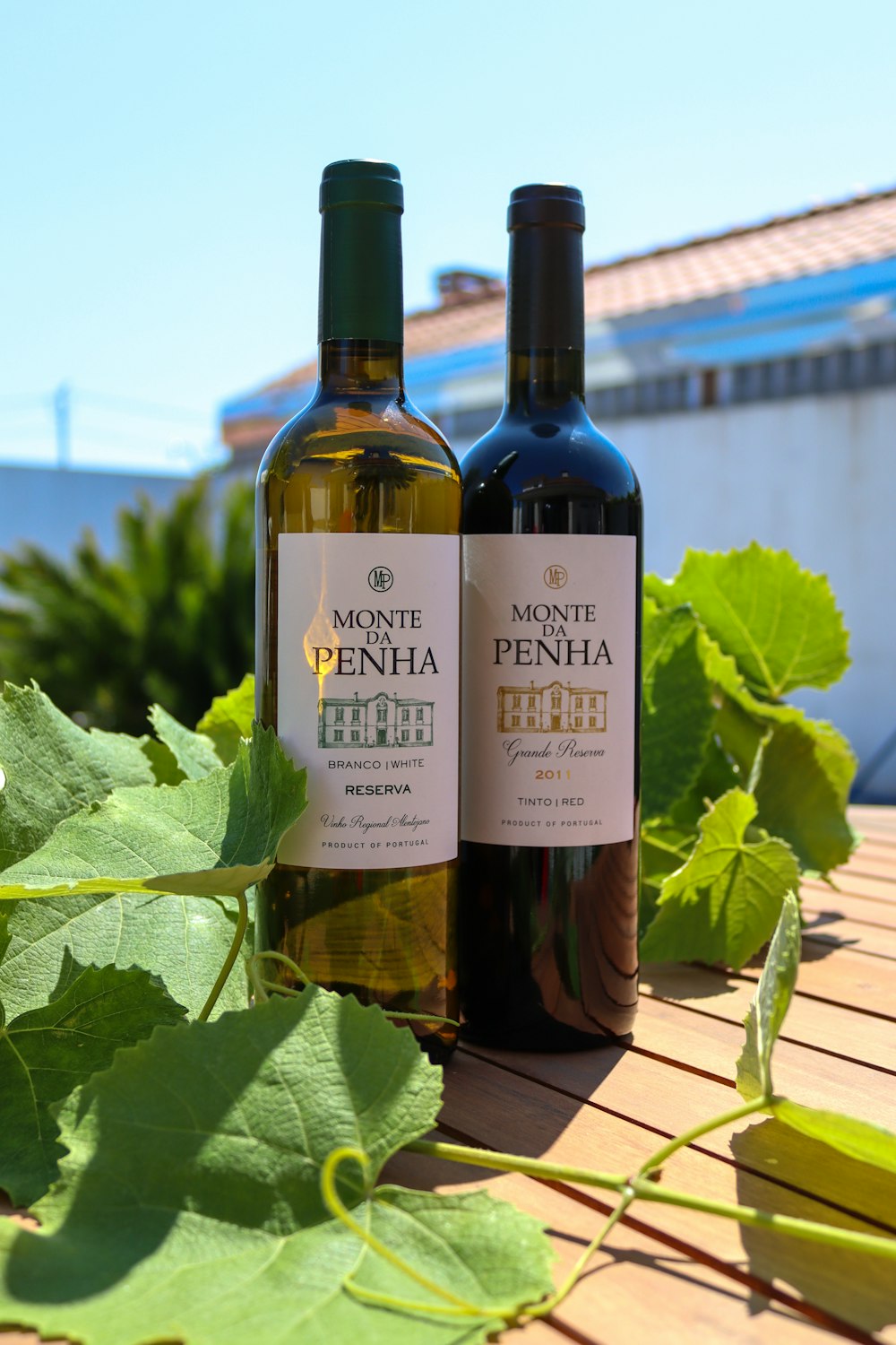 a couple of bottles of wine sitting on top of a wooden table