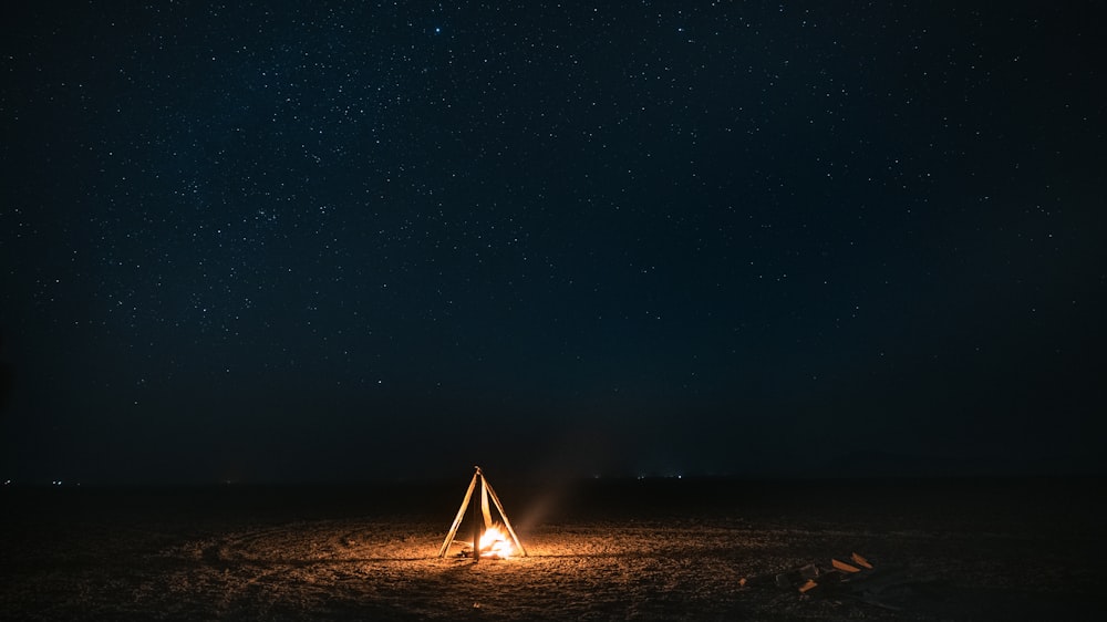 white tent on brown sand during night time