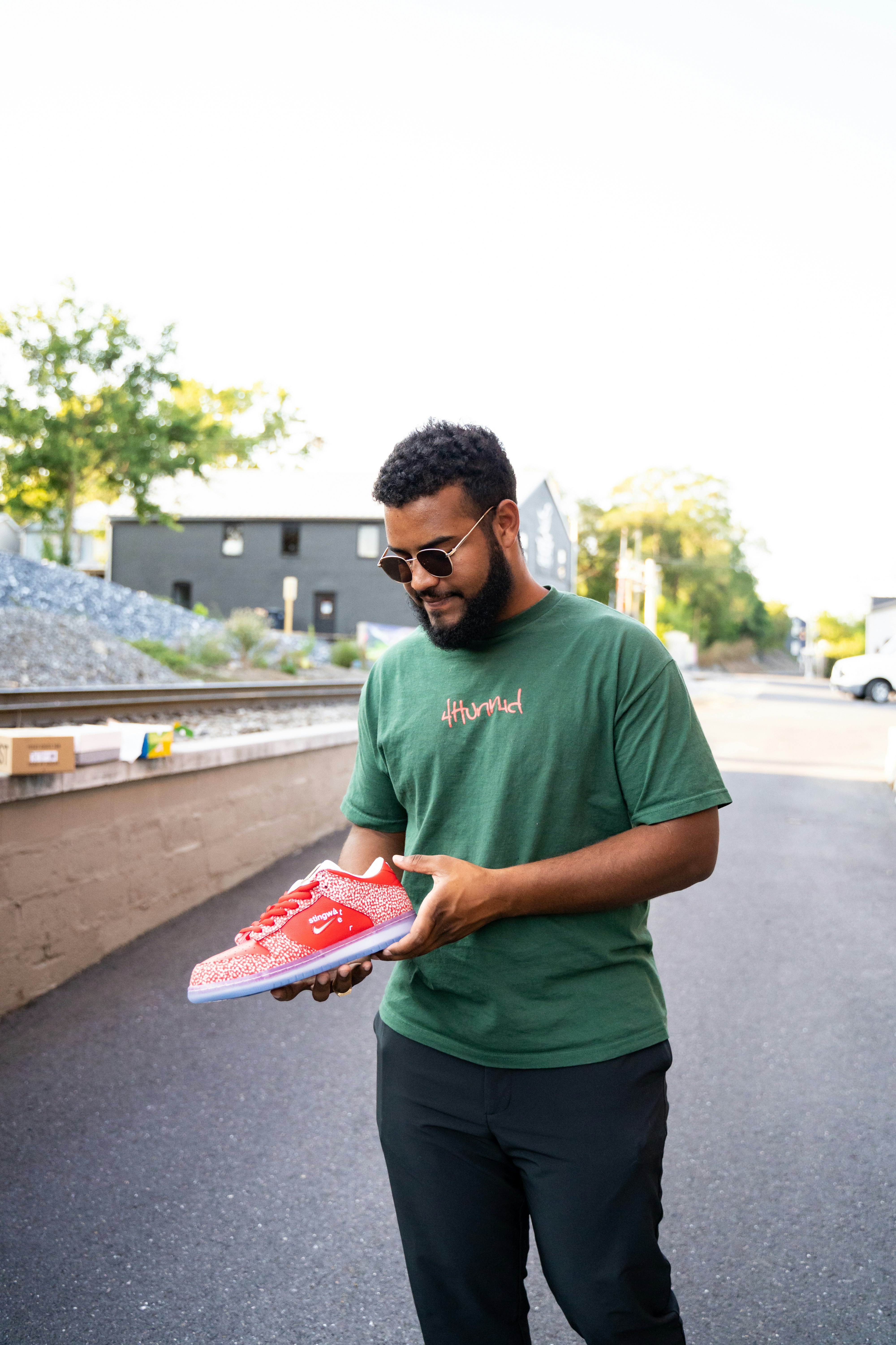 man in green crew neck t-shirt holding red tray