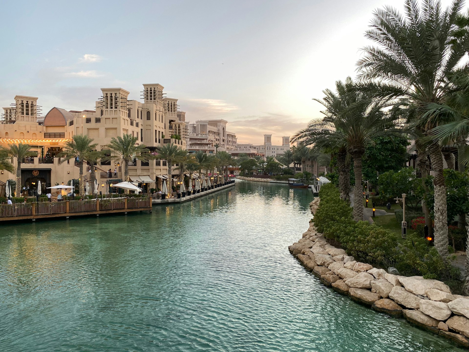 body of water near green trees and buildings during daytime