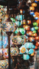 selective focus photography of blue and yellow floral pendant lamp