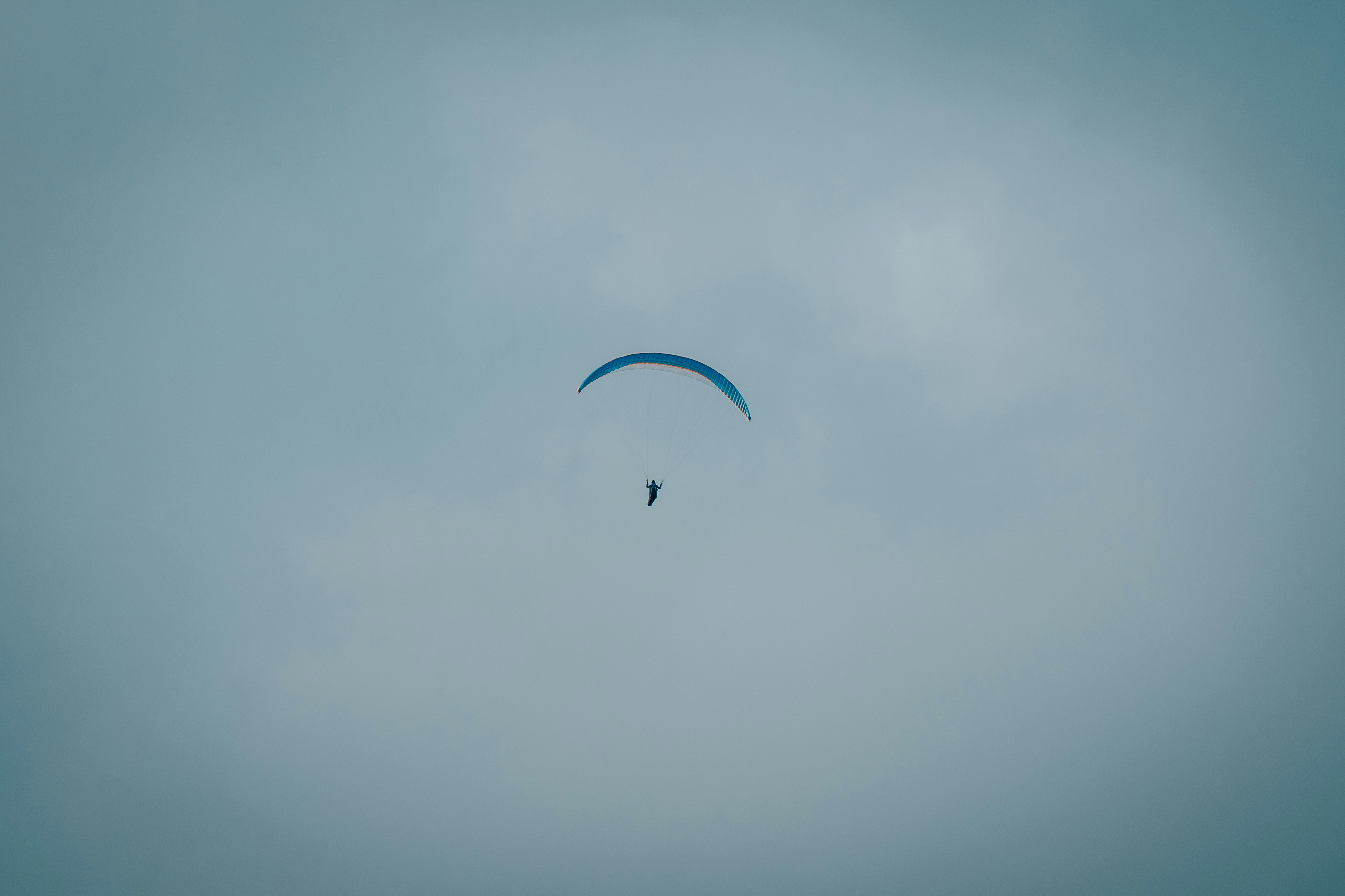 person in parachute in the sky