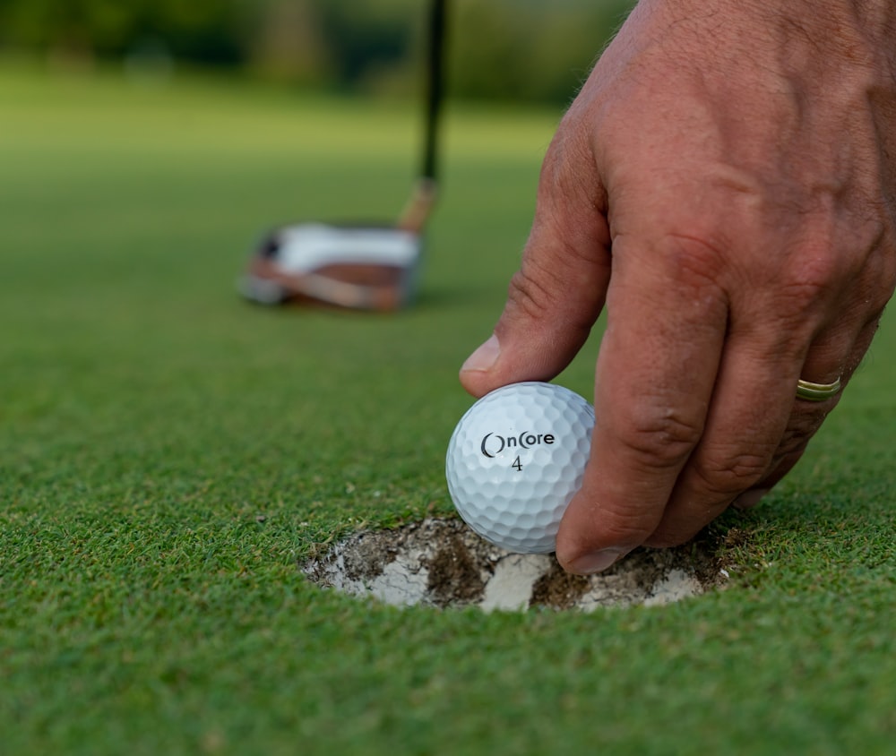 balle de golf blanche sur un terrain en herbe verte