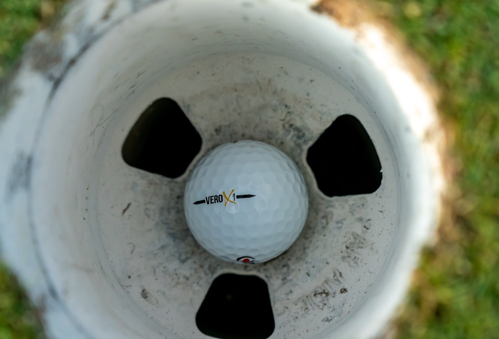 white golf ball in white hole