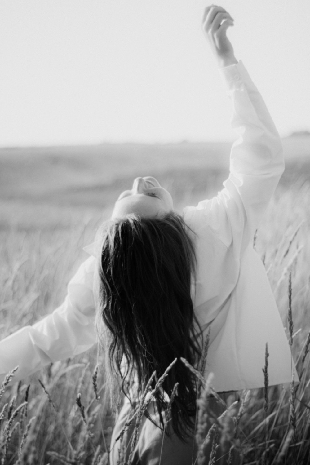 grayscale photo of woman in white long sleeve shirt