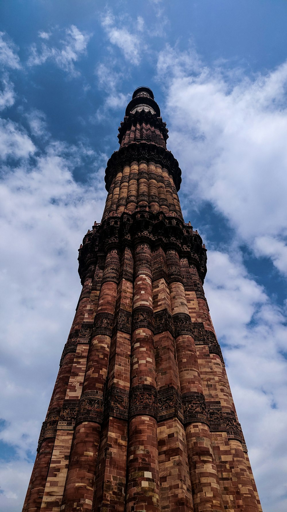 brown and black tower under cloudy sky