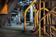 yellow metal pipe on gray concrete floor