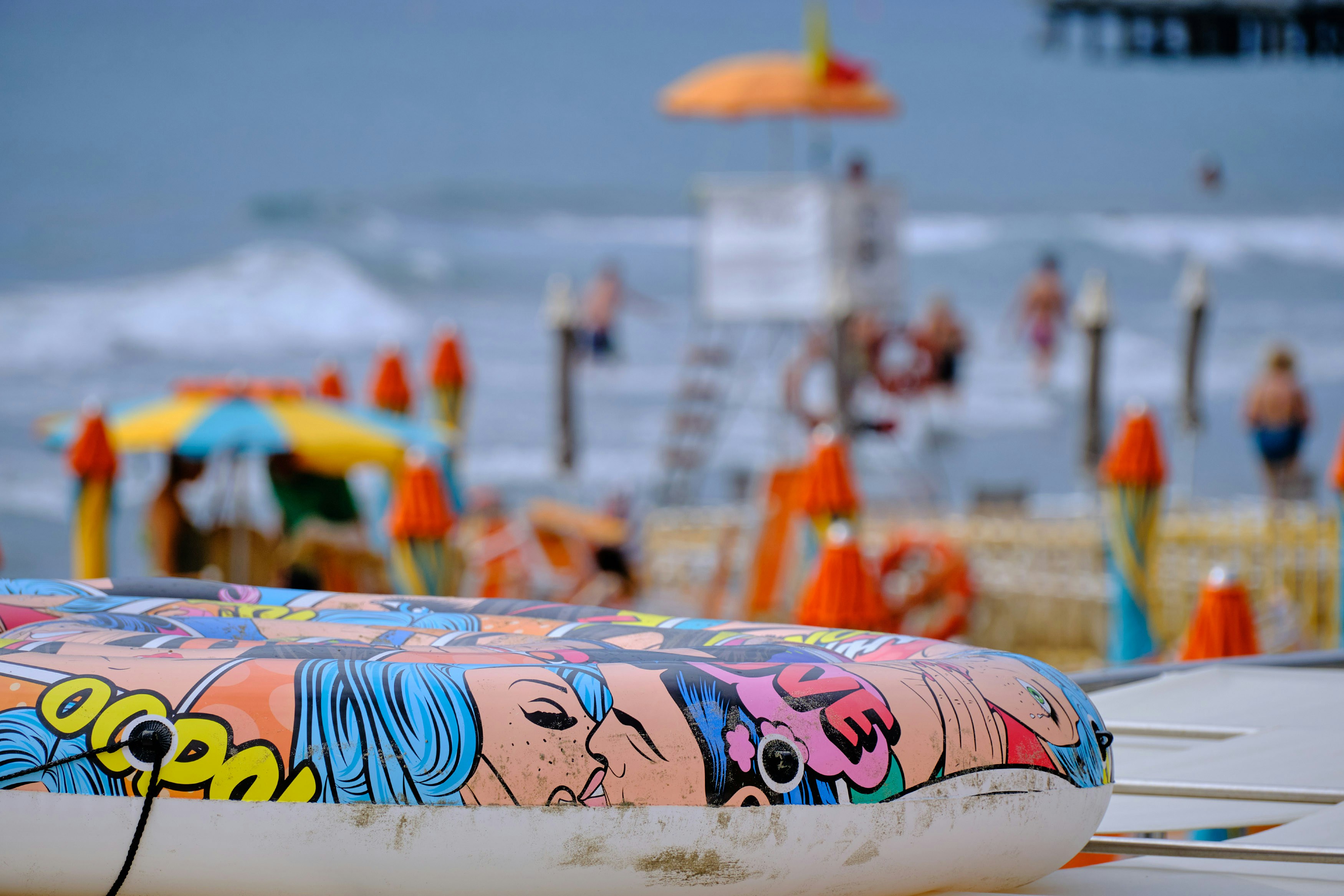 Bright and colorful beach towels laid out on a sandy shore