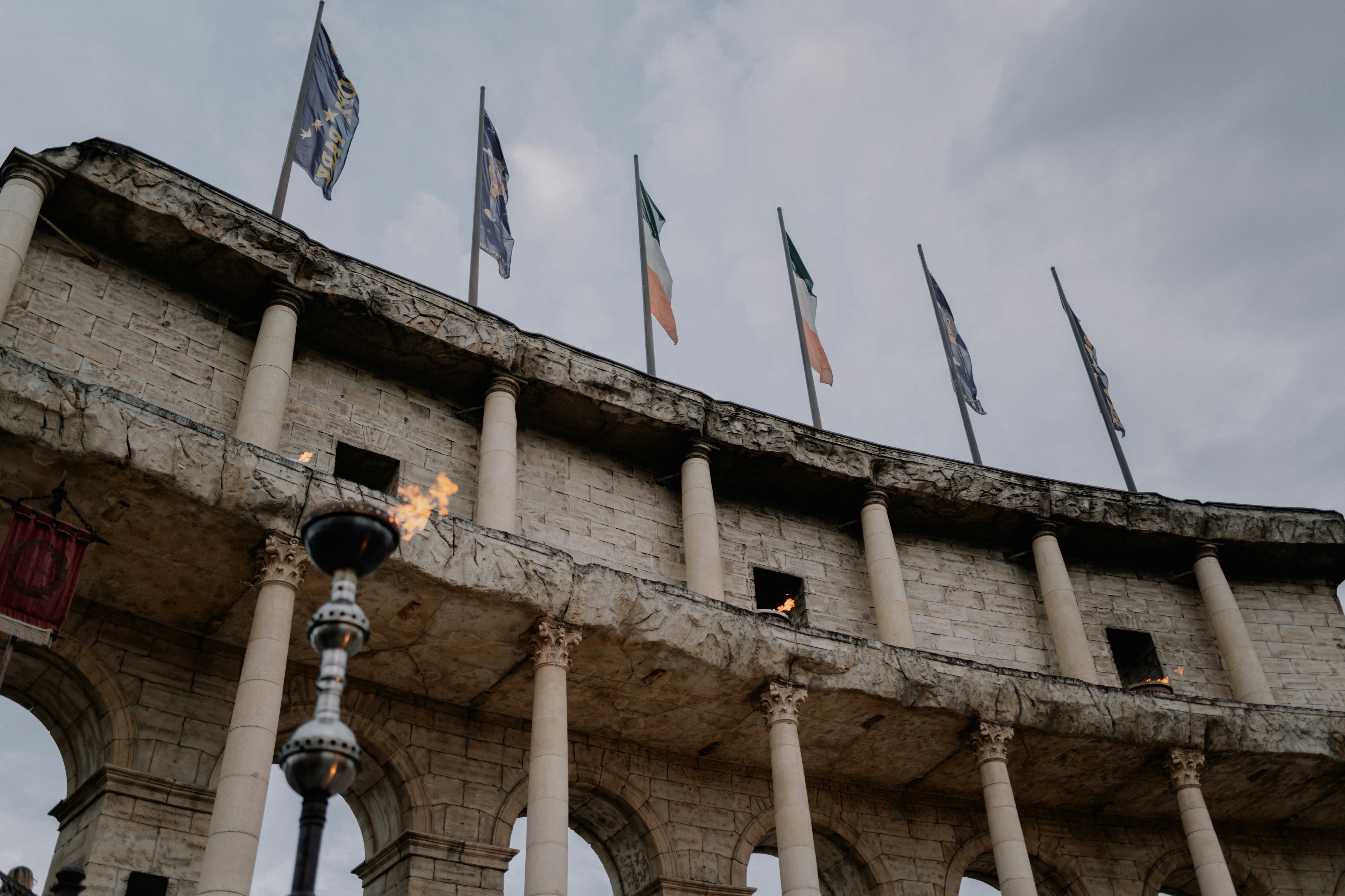 white concrete building with flags