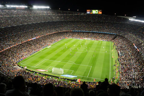 people watching soccer game in stadium