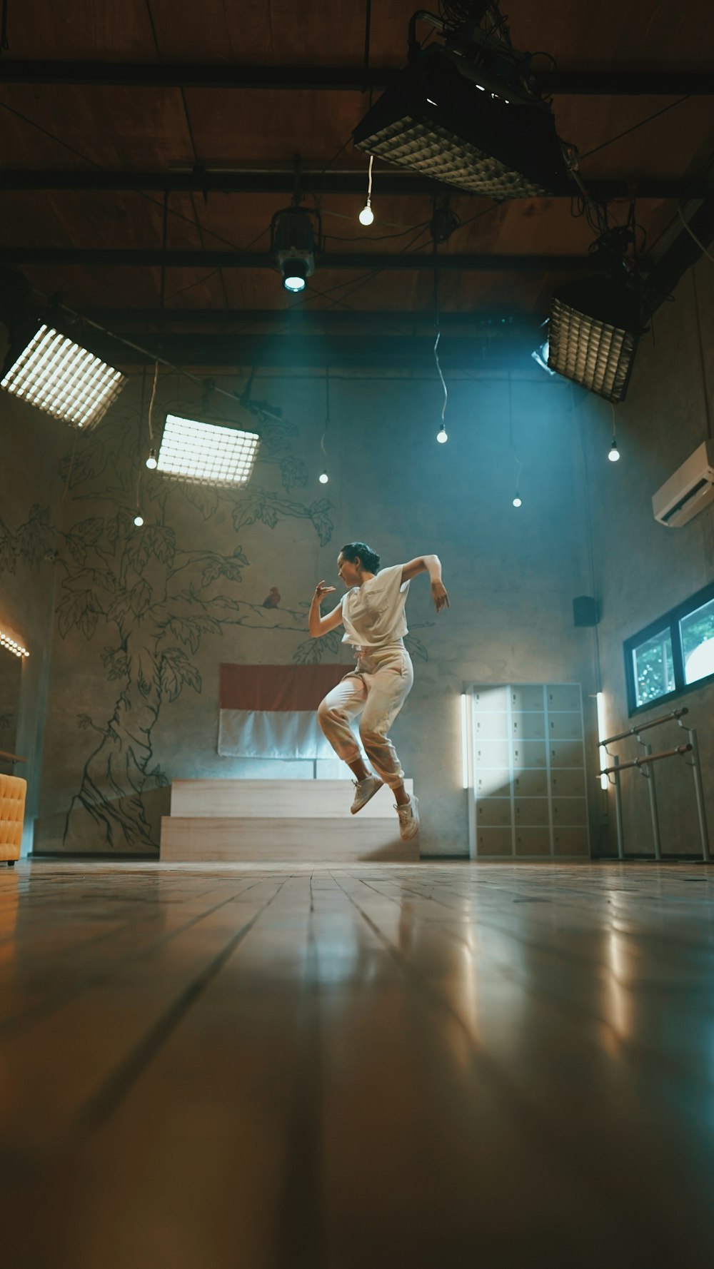man in white shirt and pants jumping on white floor