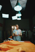 Behind-the-scenes shot of designers sketching custom t-shirt concepts in a bright studio.