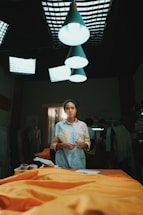 A designer working on custom merchandise in a bright studio.