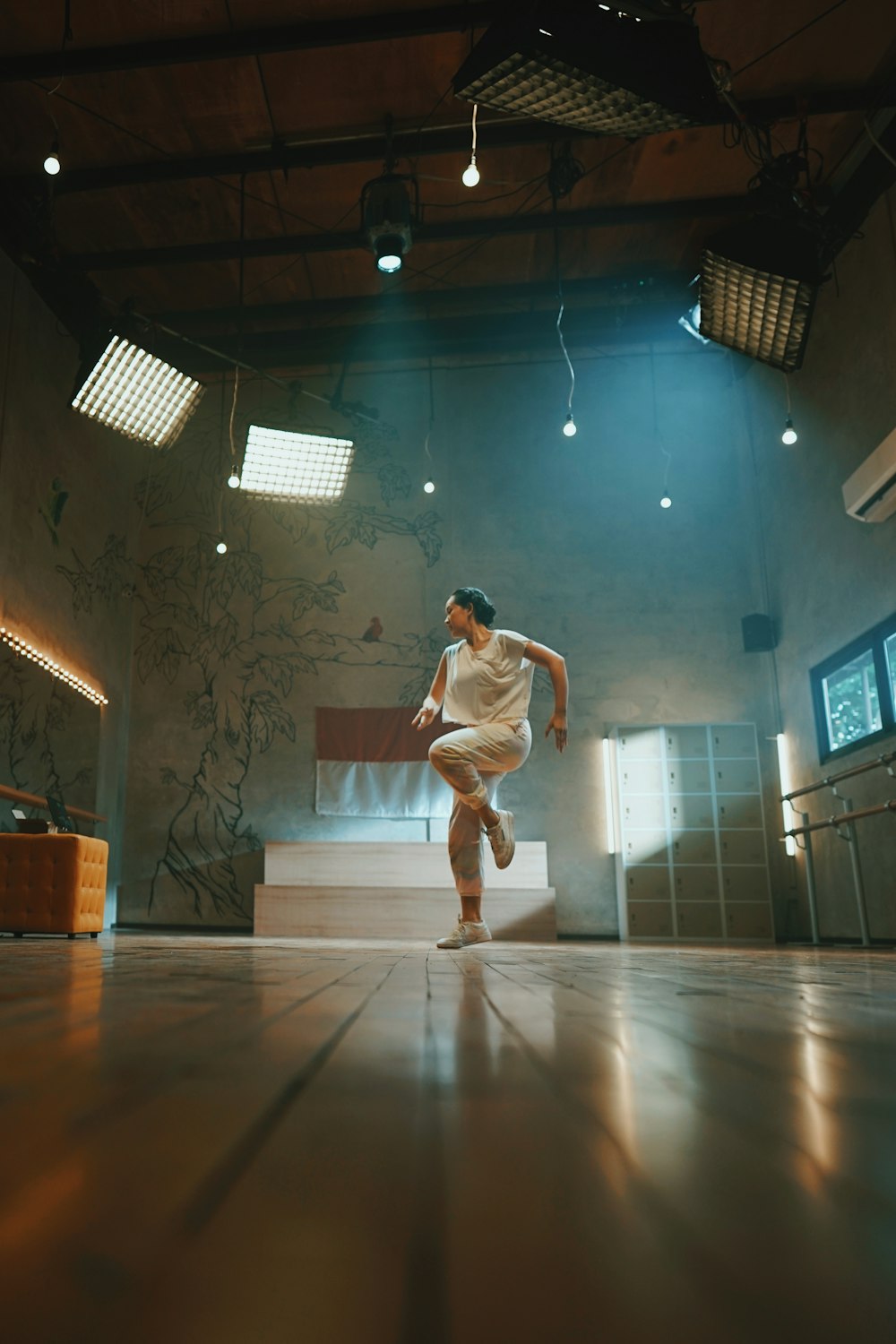 man in white t-shirt and white pants playing basketball