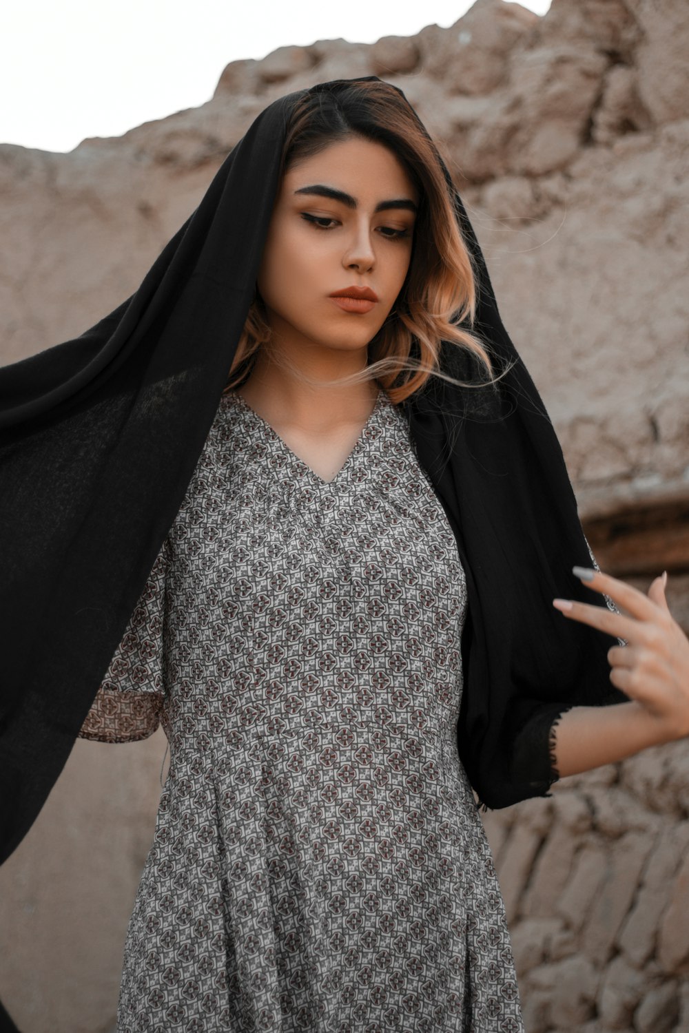 woman in black hijab and white and black checkered dress