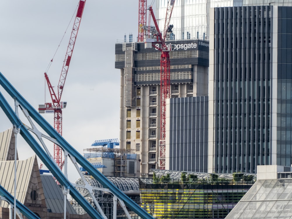 blue and red metal frame near high rise buildings during daytime