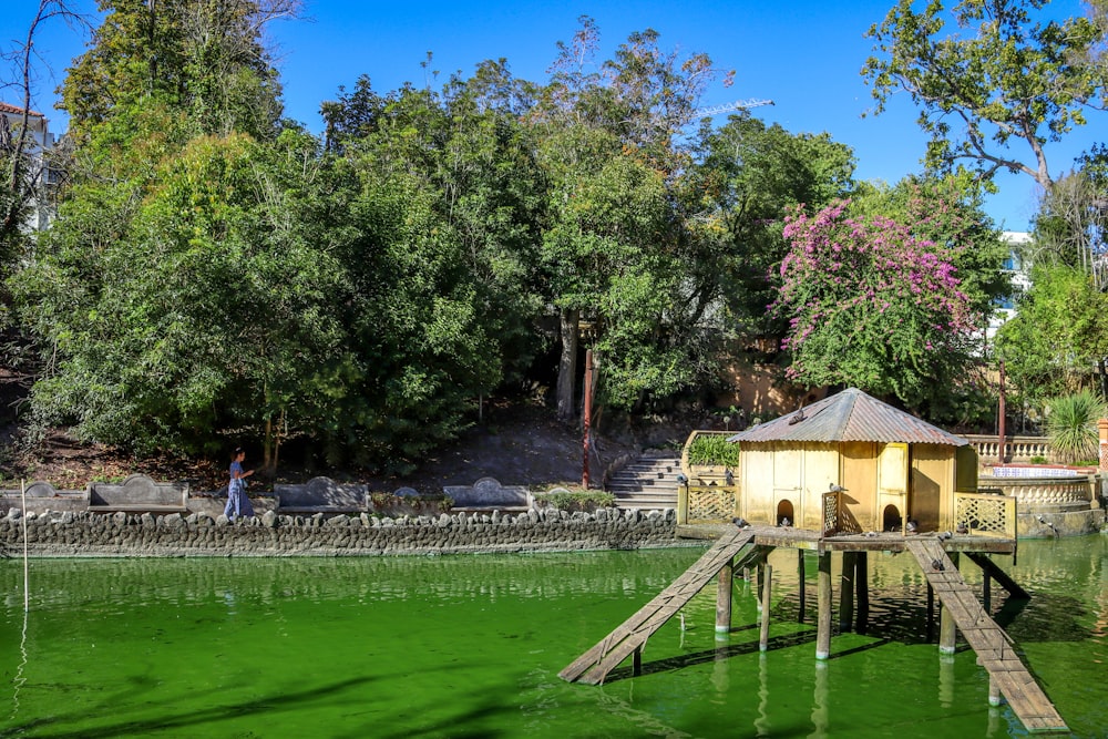 brown wooden gazebo near green trees during daytime